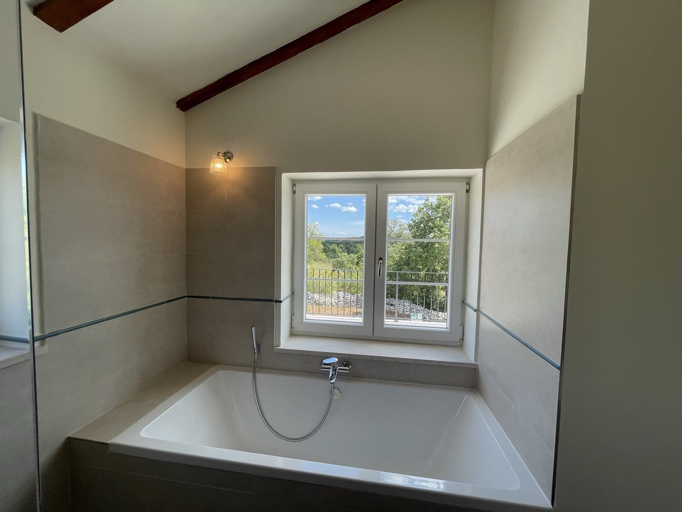 The bath set under a window looking over the fields