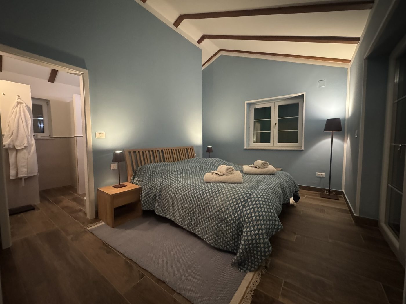 The master bedroom, blue walls and open beams